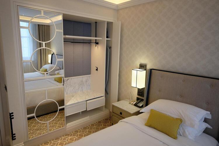 Image de la chambre d'hôtel montrant un lit et un dressing